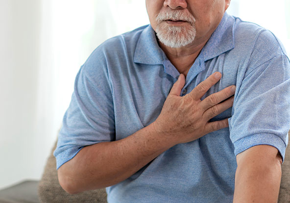 Older man holding chest