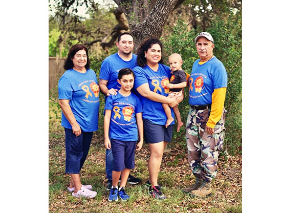 Declan and his family posing for a family picture with matching Tshirts
