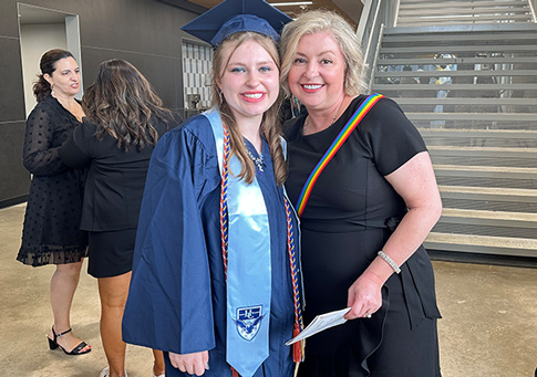 Havely stands with a family member in her cap and gown at her graduation after recovering from surgery