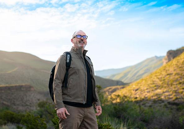 Dr. Lancaster standing in front of a mountain in Alamogordo, NM