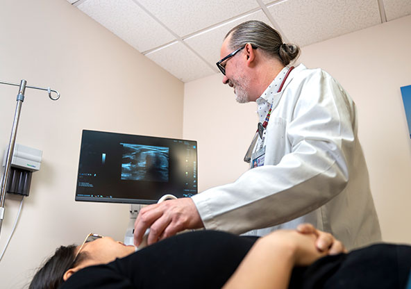 Dr. Lancaster with a patient in his office