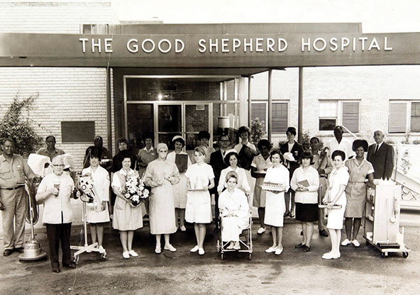 A retro image of health care staff standing at the entry at the new Good Shepherd Hospital